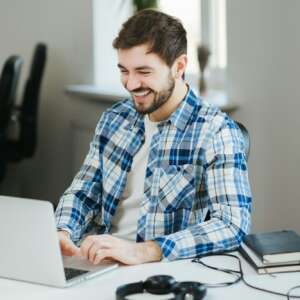 Happy man working on laptop